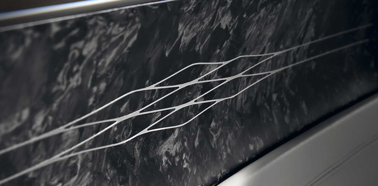 Embroidered metal paper matrix pattern on forged carbon