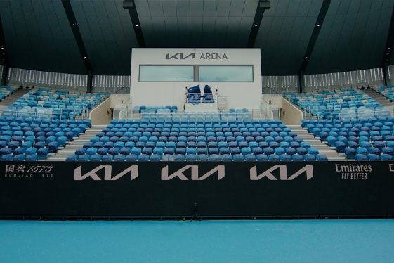 The tennis court inside Kia Arena. The Kia logo is engraved everywhere