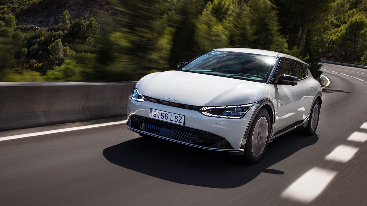 A snow-white pearl-colored EV6 is running on the road