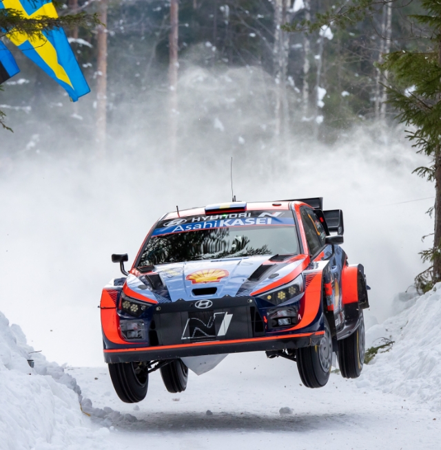Hyundai i20 N WRC Rally 1 jumps while driving in Rally Sweden