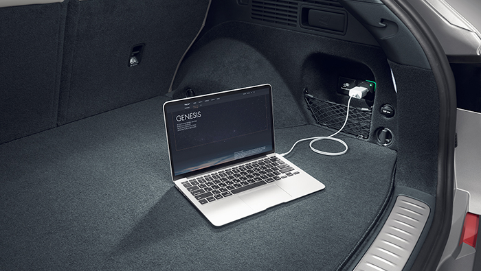 Electrified GV70 charging laptop with V2L in the trunk