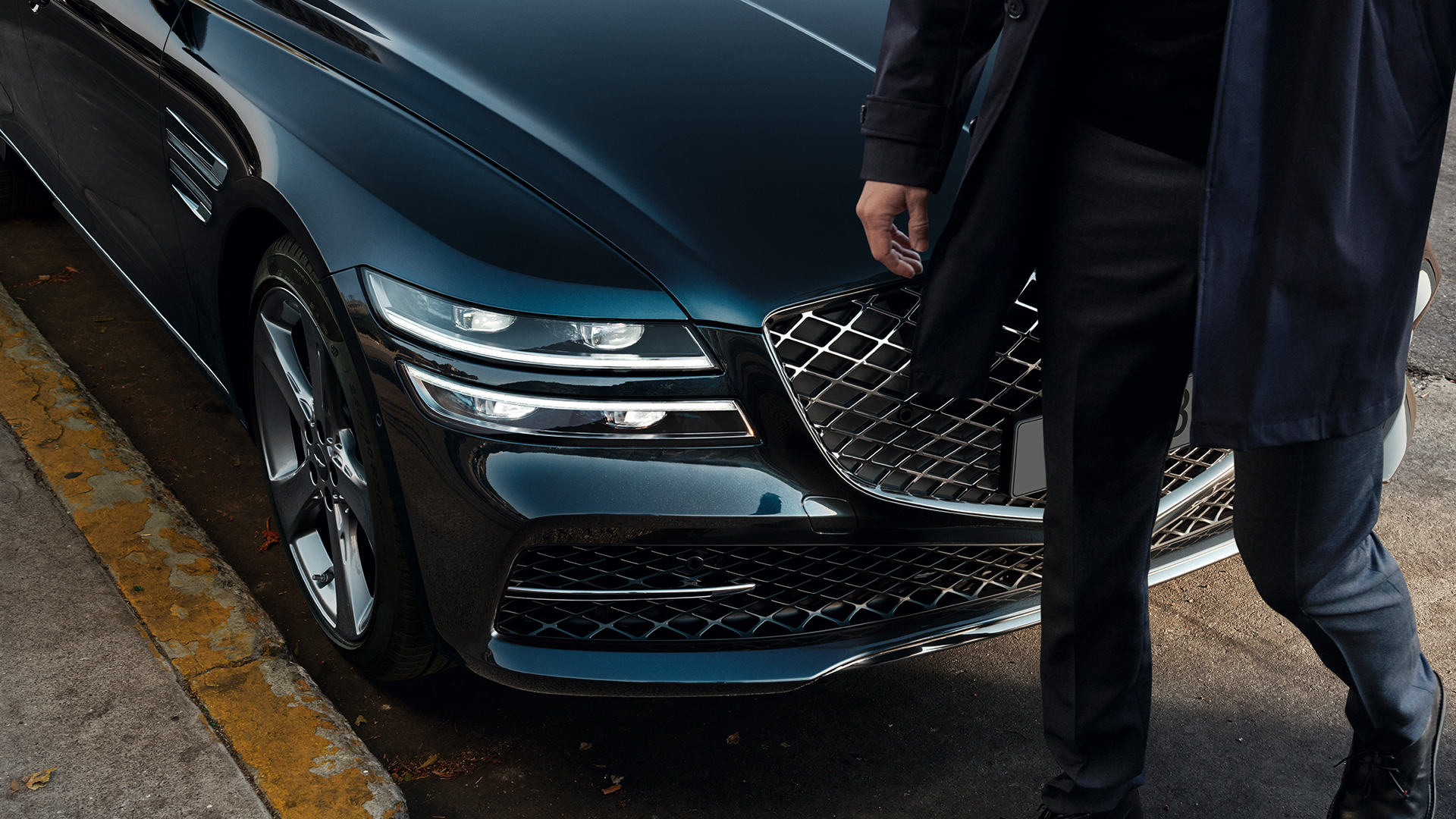 a person is standing in front of the Genesis G80