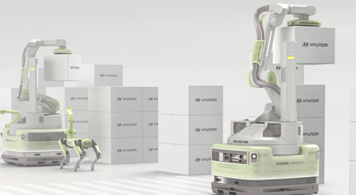 상자를 들어 올리는 로봇 스트래치와 4족 보행 로봇 스팟의 모습