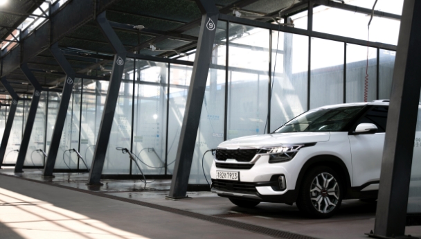 셀프 세차장 부스에 서 있는 기아 셀토스