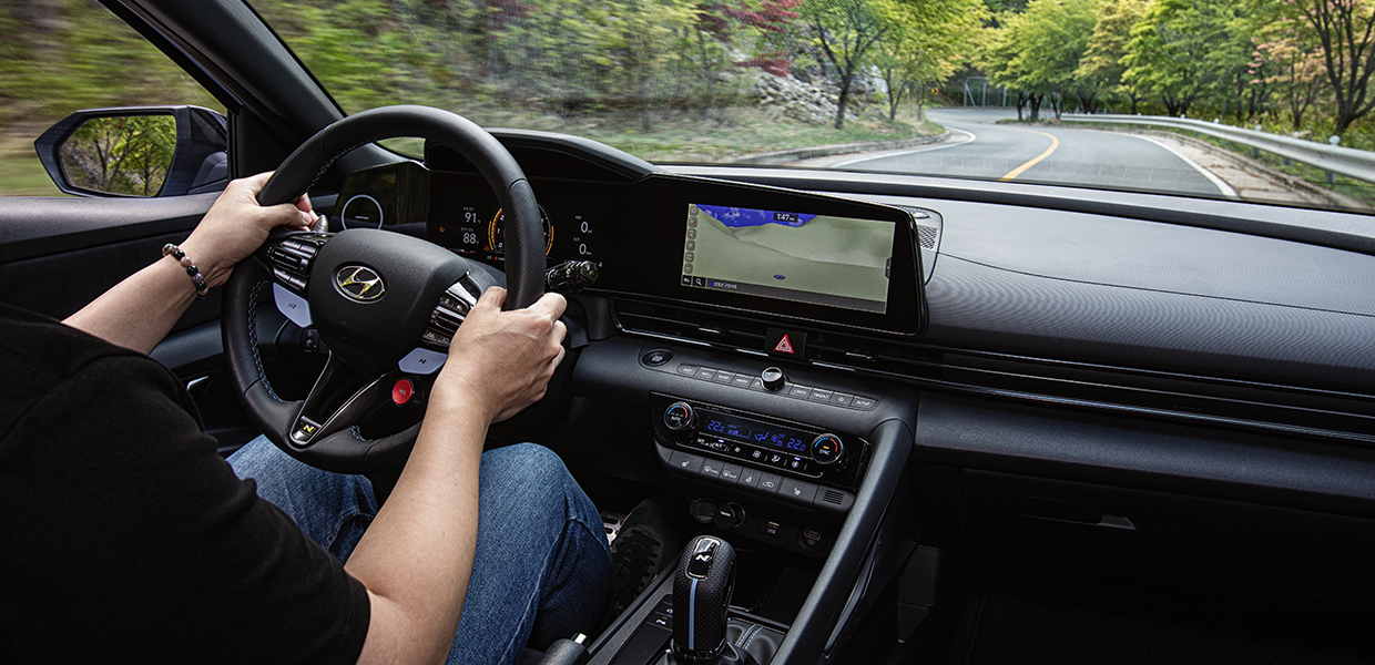 A man is driving a Hyundai Avante N