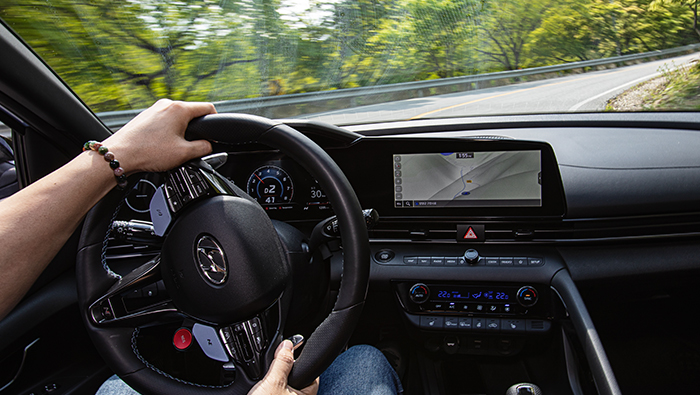 A man is driving a Hyundai Avante N