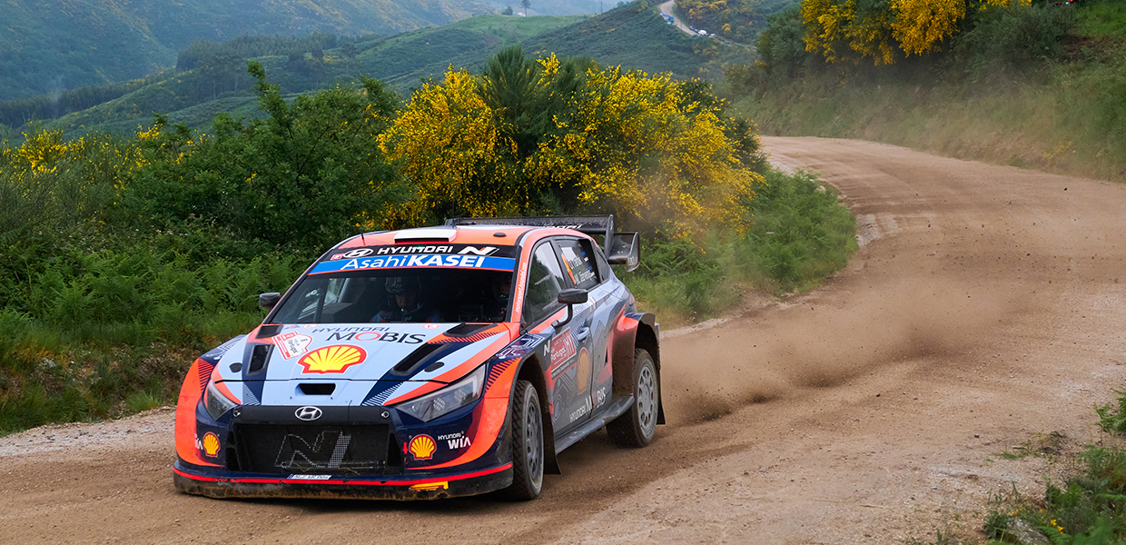 i20 rally car driving on a mountain road in a beautiful scenery