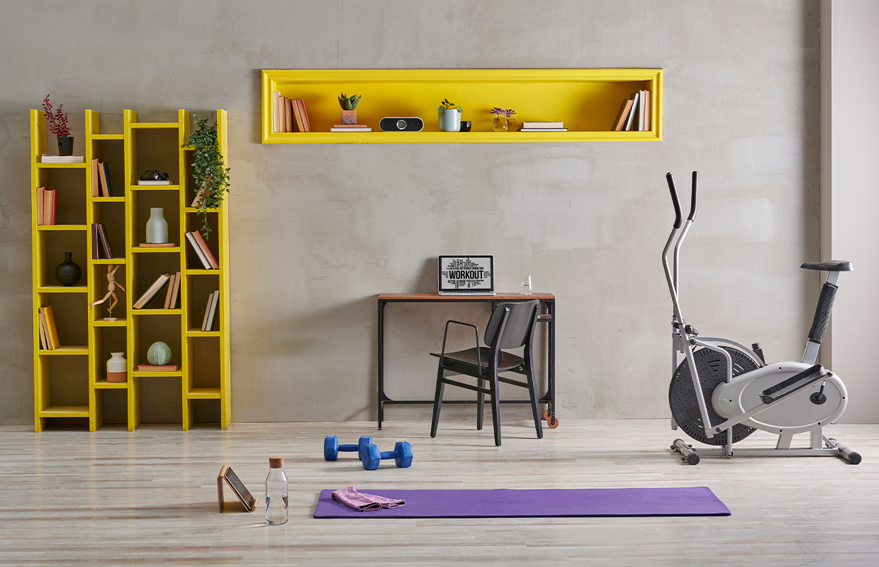 Interior view with exercise equipment, bookshelves and desks
