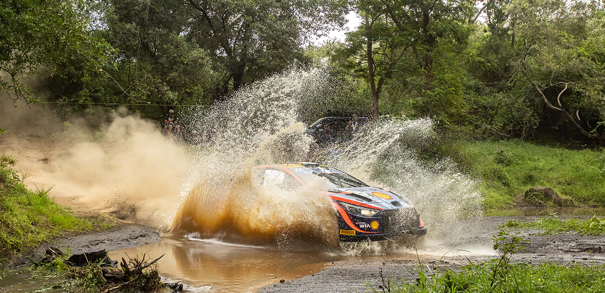 Hyundai i20 N WRC Rally 1 passing through a deep puddle