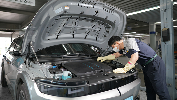 A train mechanic is checking the IONIQ 5