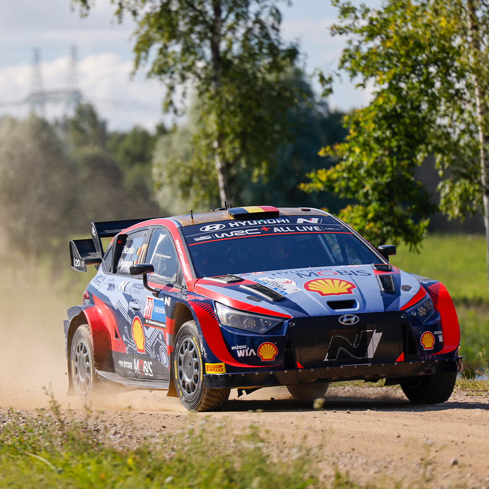 Hyundai Rally Team's i20 rally car is driving down a rough road
