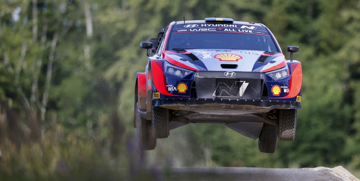 The i20 rally car is jumping on the course