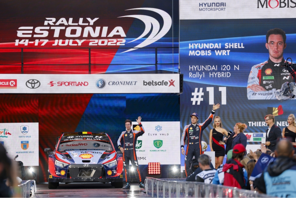 Thierry Neuville and his co-driver Martijn Wydaeghe pose on stage