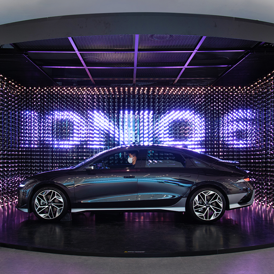 The IONIQ 6 is displayed with a crystal LED in the background