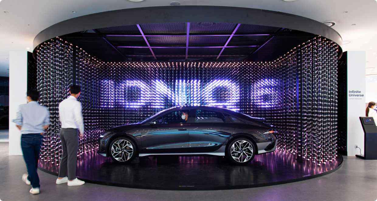 The IONIQ 6 is displayed with a crystal LED in the background