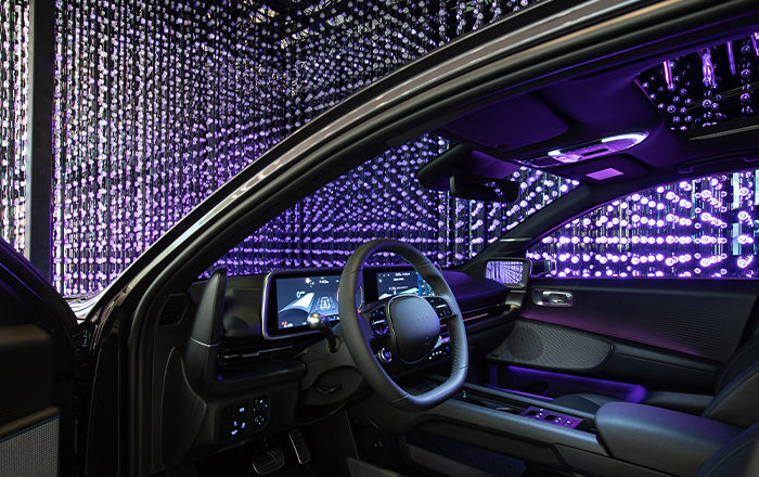 The driver's seat of the IONIQ 6 displayed with a crystal LED in the background