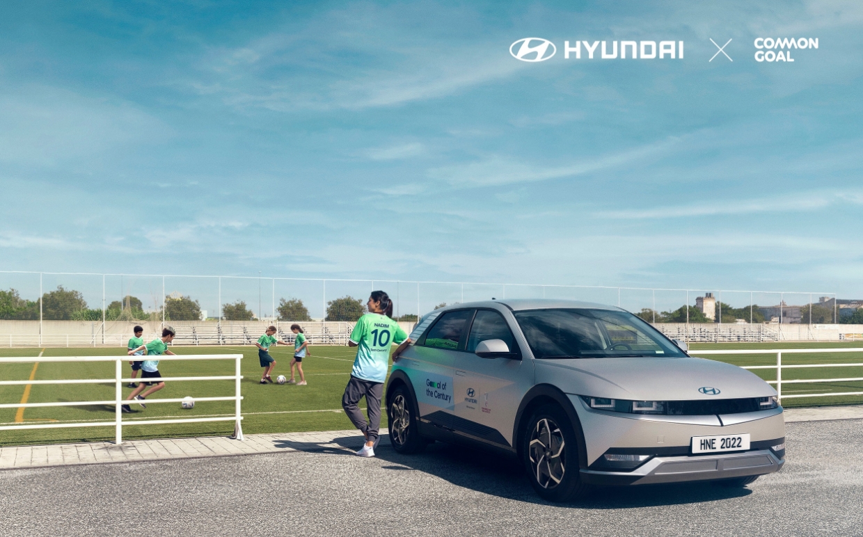 Ioniq 5 standing next to a soccer field