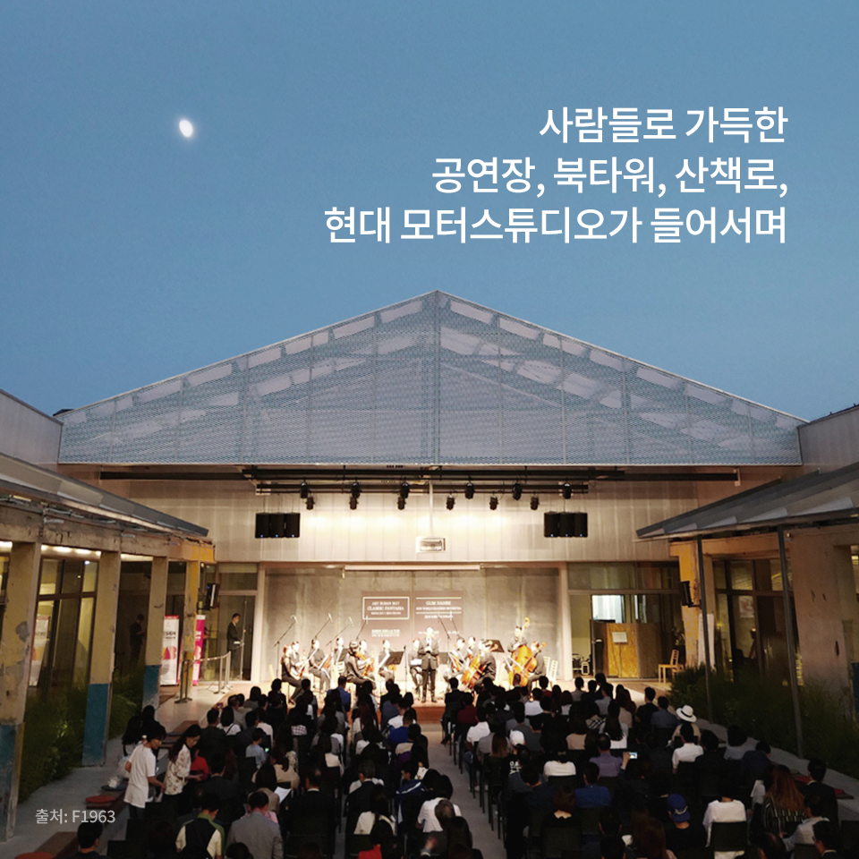 F1963의 중정에서 진행하는 악기 연주를 감상하는 관객들