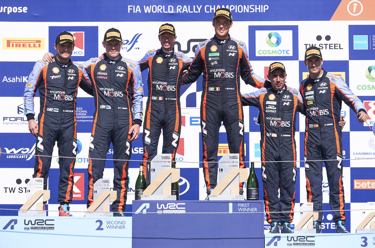 WRC Hyundai Motorsport racers conquering the podium at the WRC 2022 Rally Greece