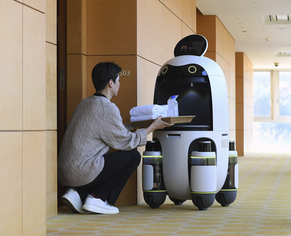 A person taking items out of a delivery robot