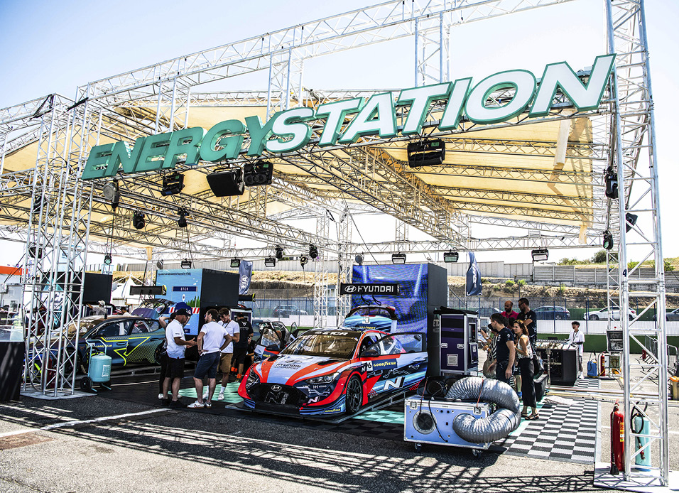 A Veloster racing car parked at an energy station