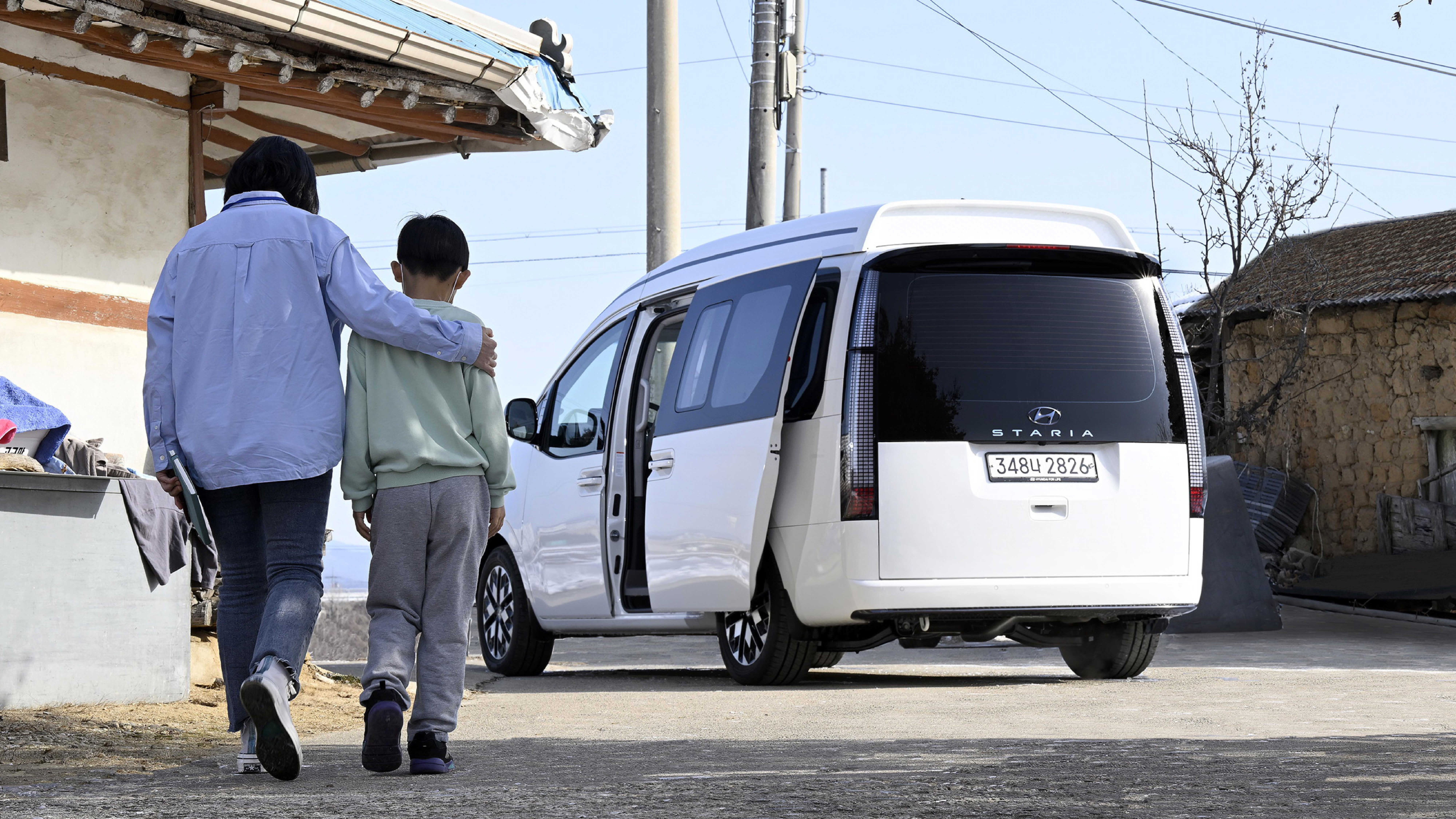 상담사와 아이가 아이케어카로 걸어가는 모습