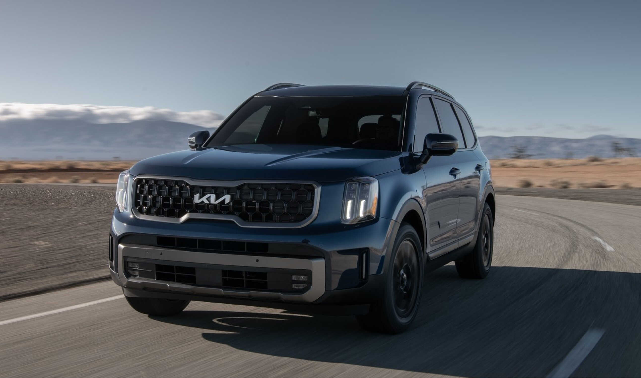 Kia Telluride driving on a desert road