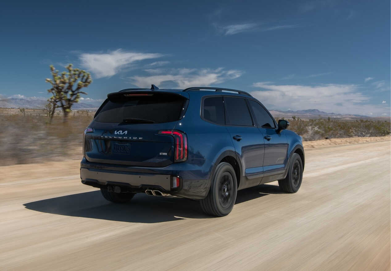 Kia Telluride driving on a desert road