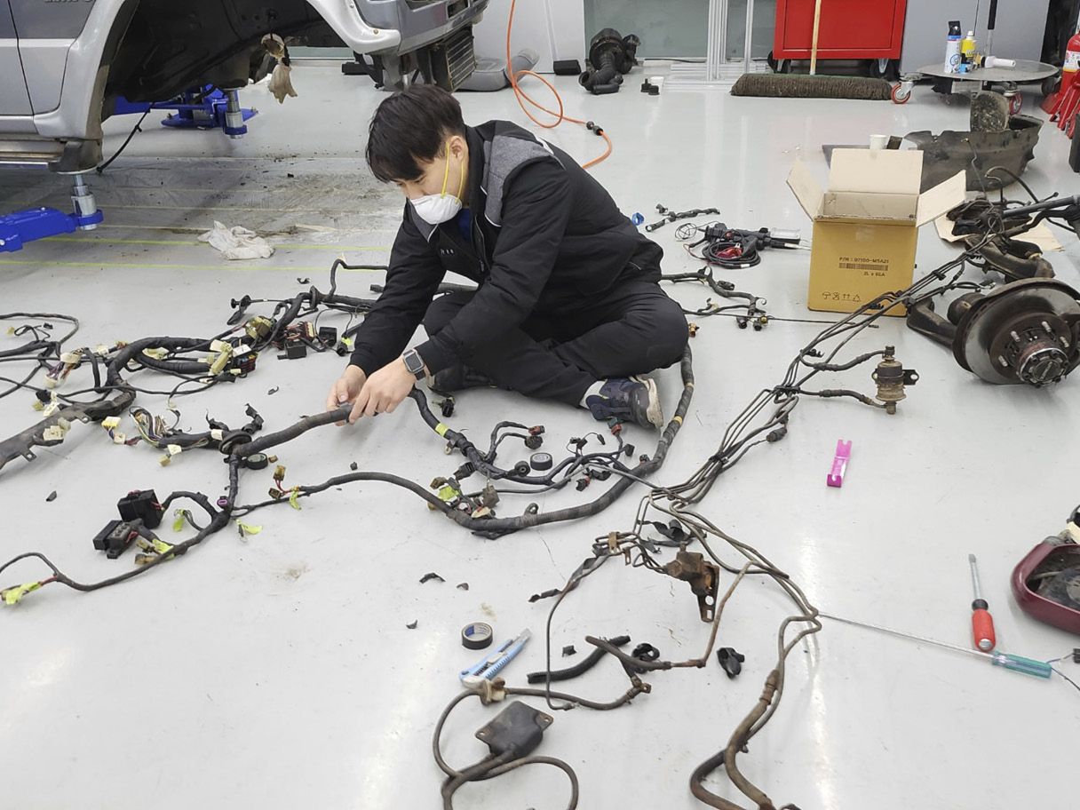 A worker checking the wiring harness