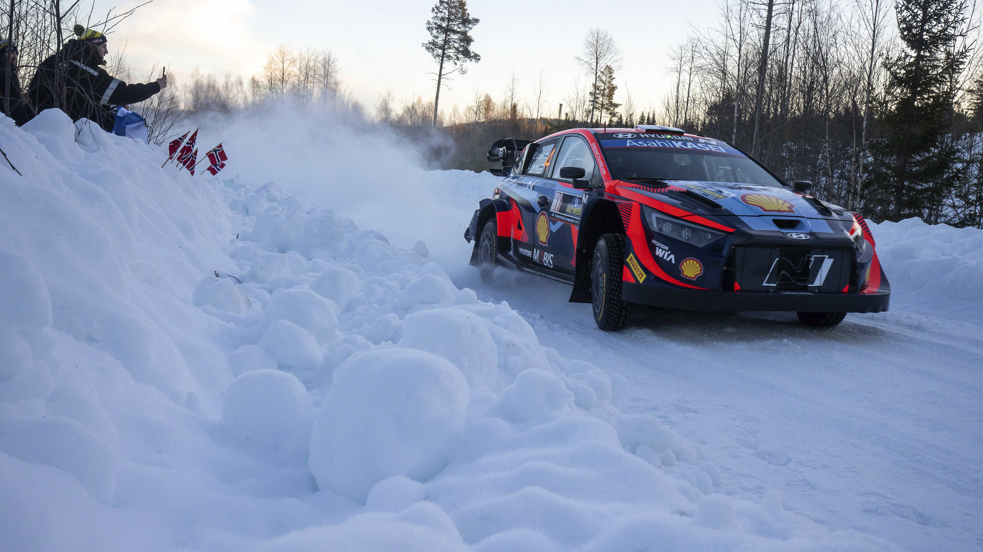 A Hyundai Motorsport race car running on a snowy road