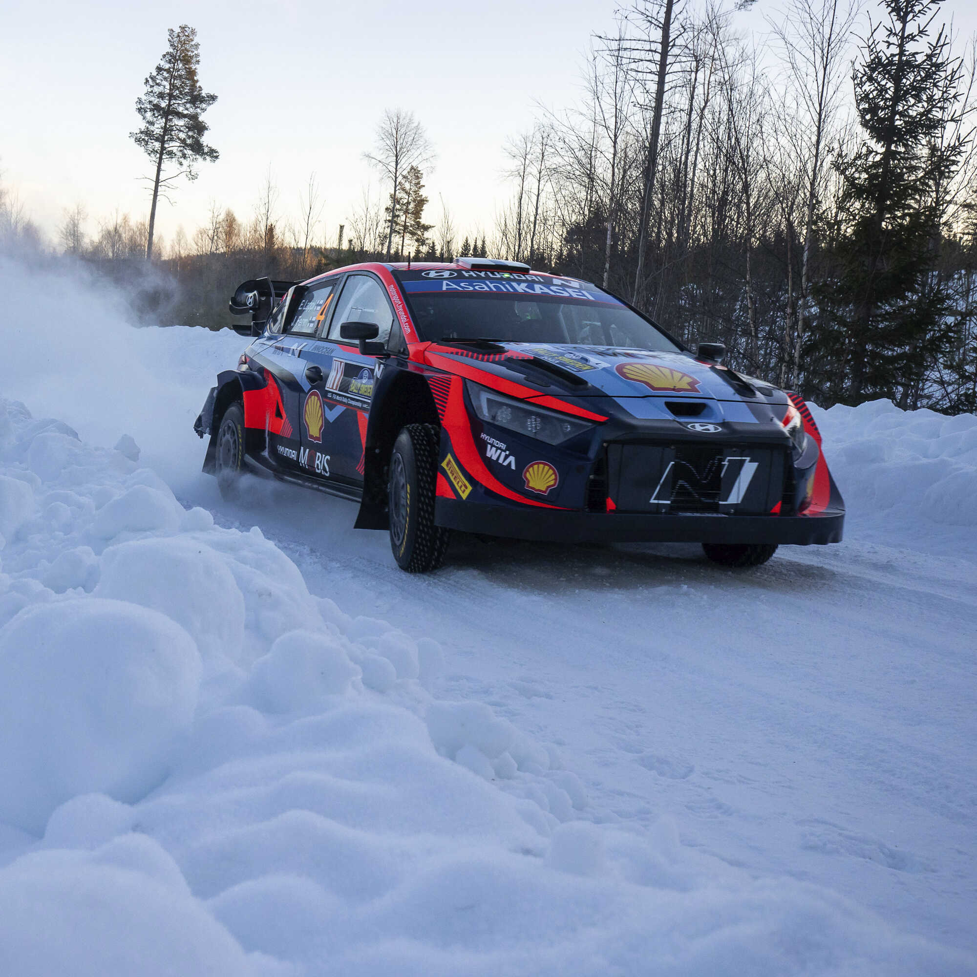 A Hyundai Motorsport race car running on a snowy road