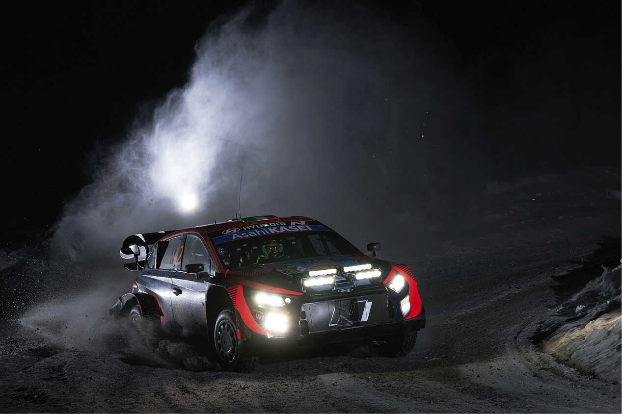 Hyundai's rally car running at night with headlamps on