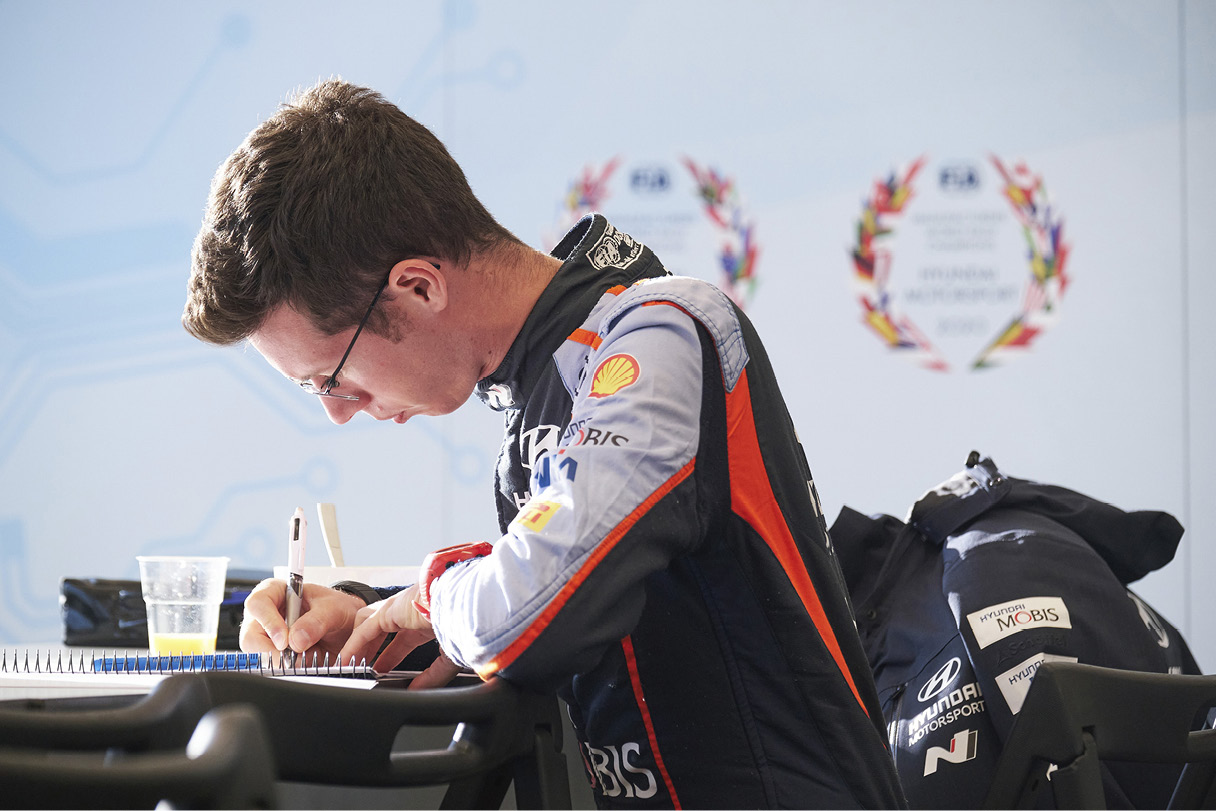 A co-driver taking notes about the course