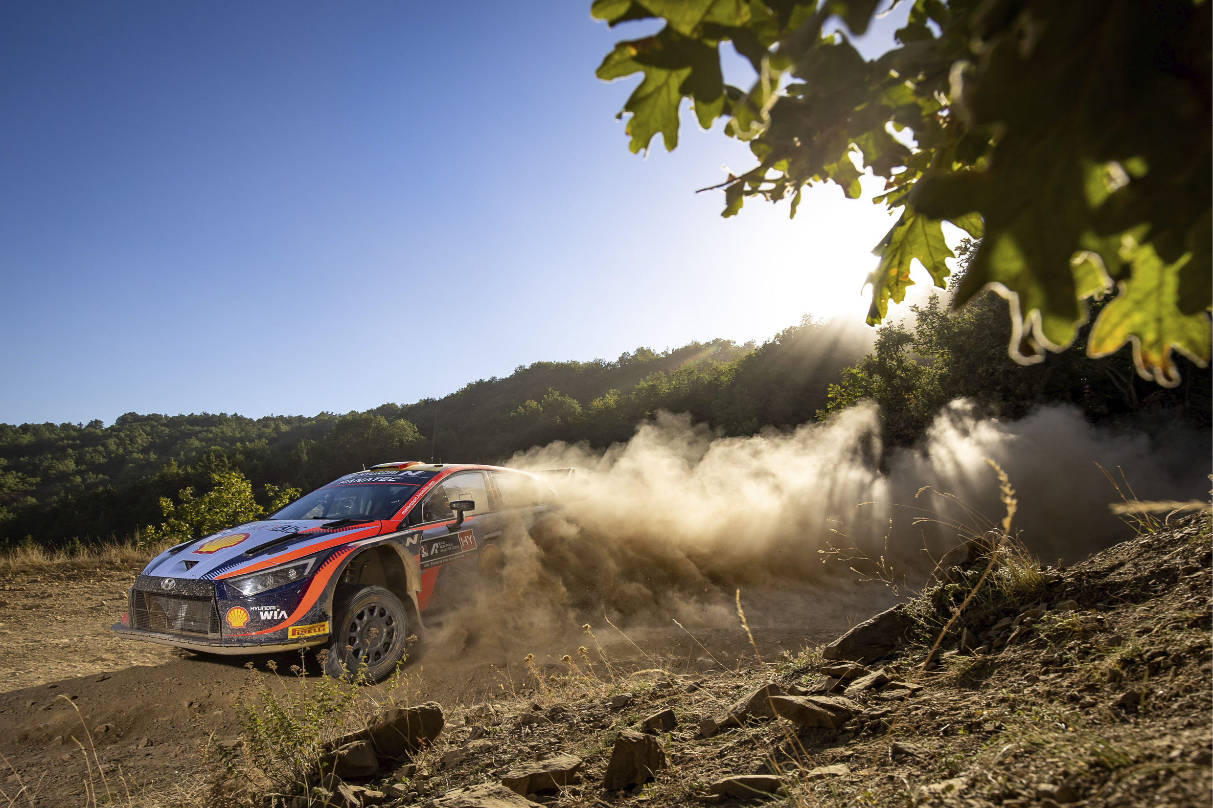 A WRC racing car running through the dirt