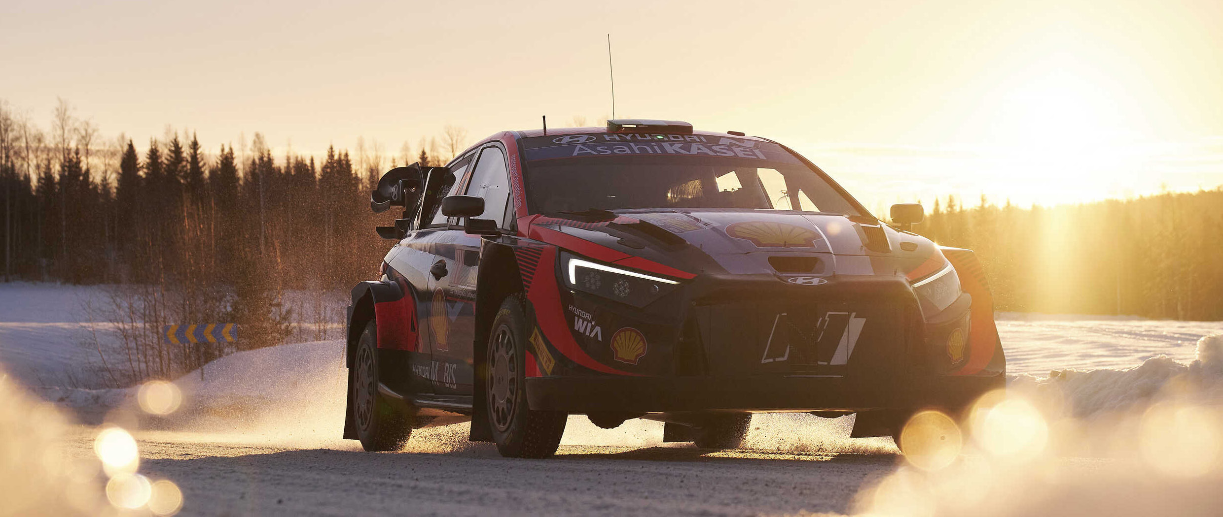 A rally car stopped on a snowy field