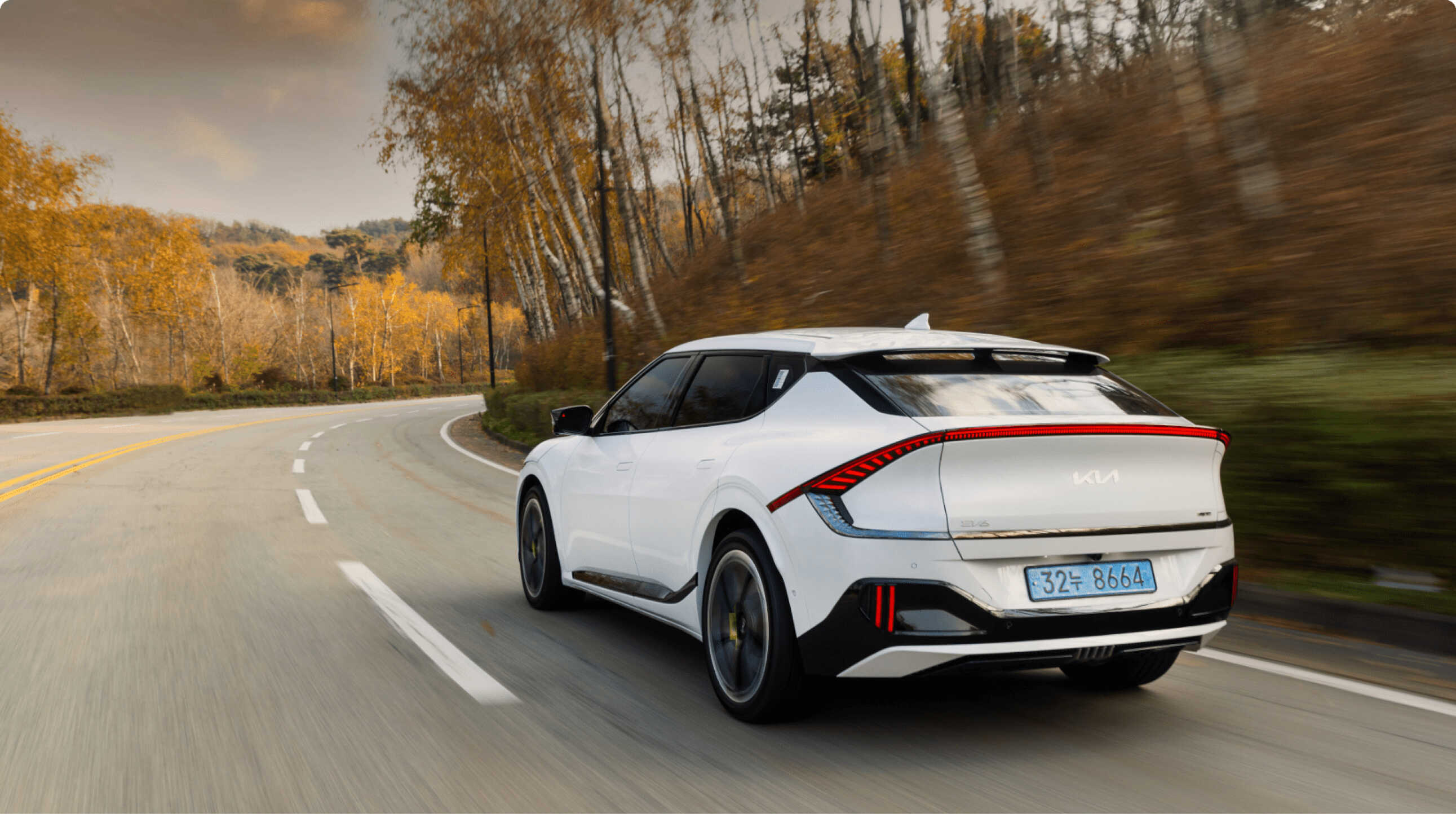 Rear view of Kia EV6 driving on a winding road