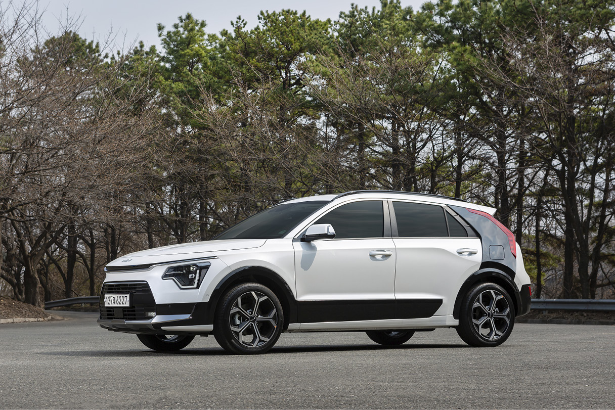 A white Niro parked in empty space