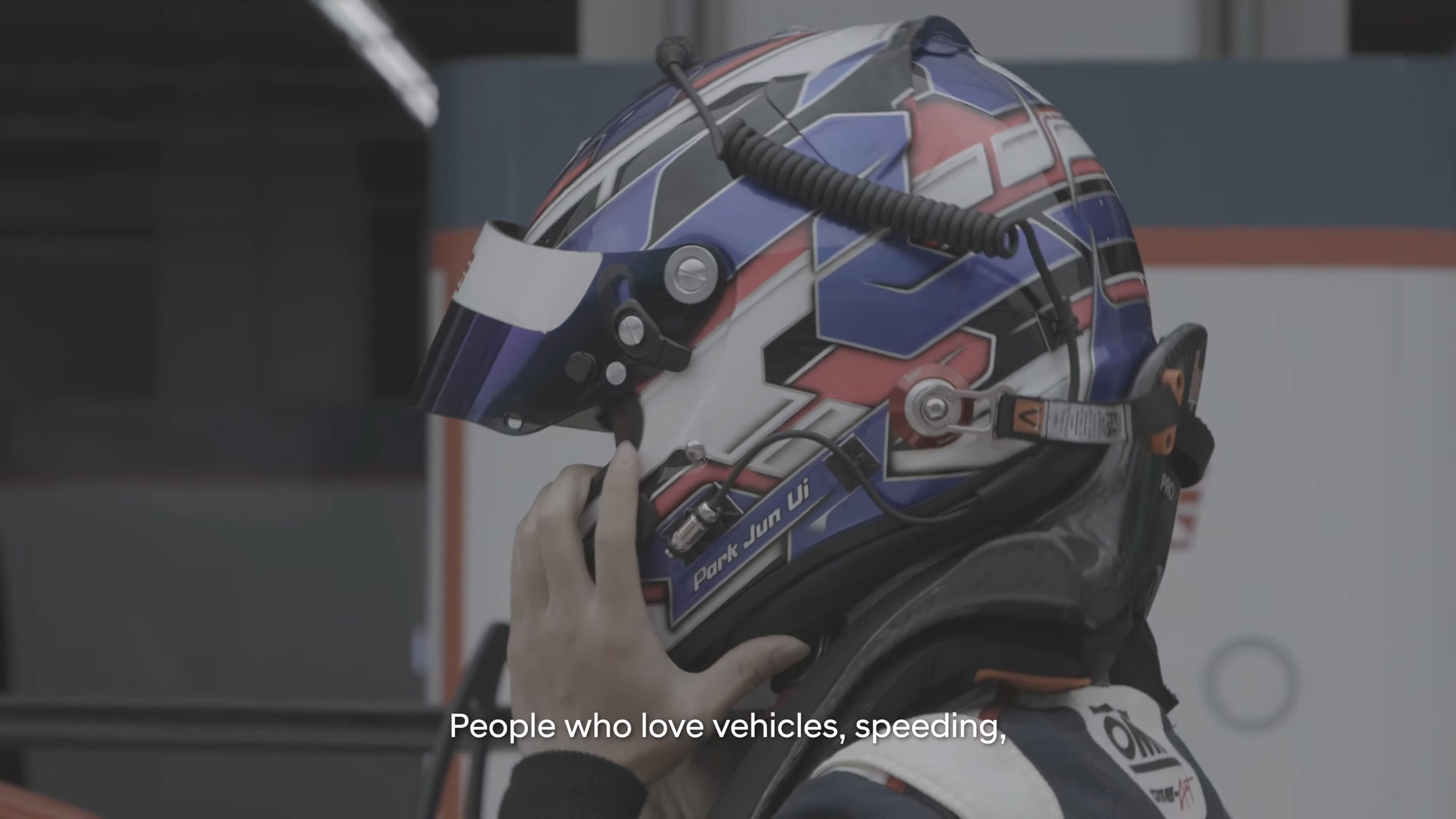 A junior driver is wearing a helmet