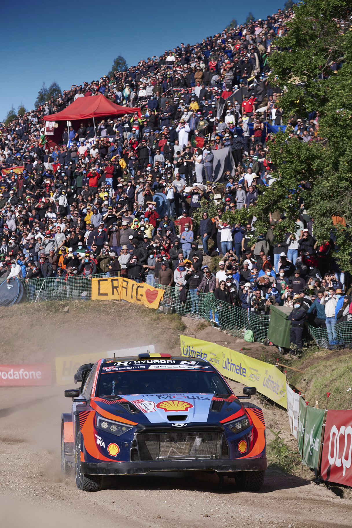 Hyundai i20 N Rally 1 and passionate audience running at Rally Portugal