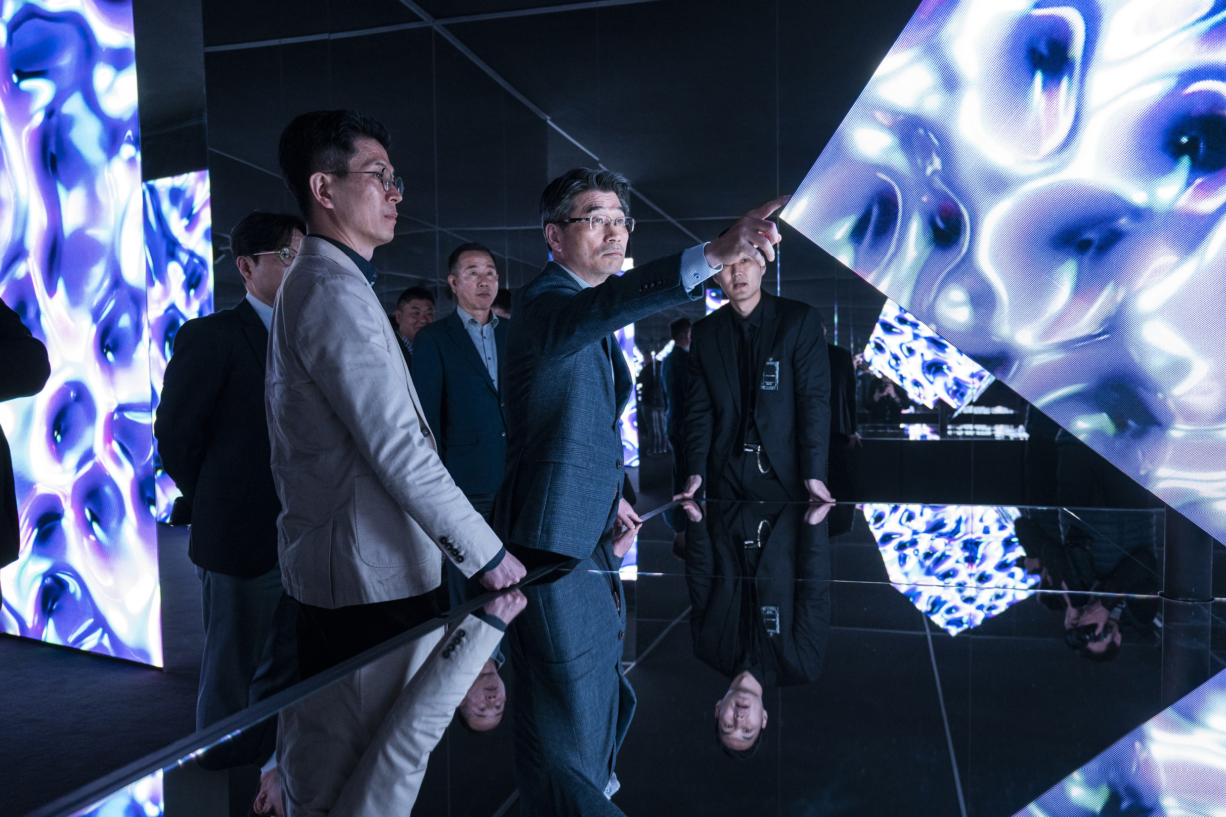 Kia Motors CEO Ho-sung Song and faculties appreciating the Opposites United exhibition