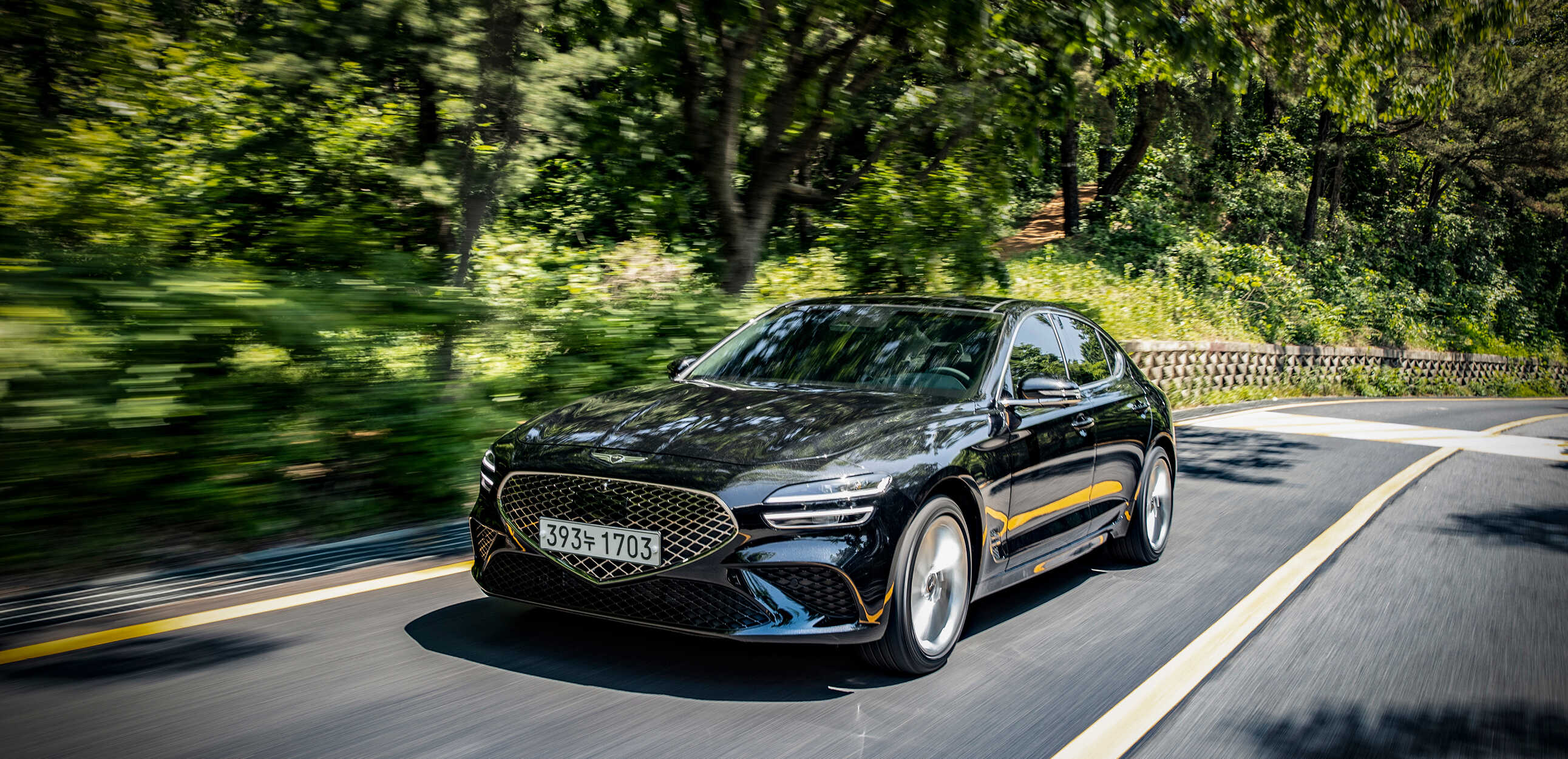 Front view of the G70 driving on a hill