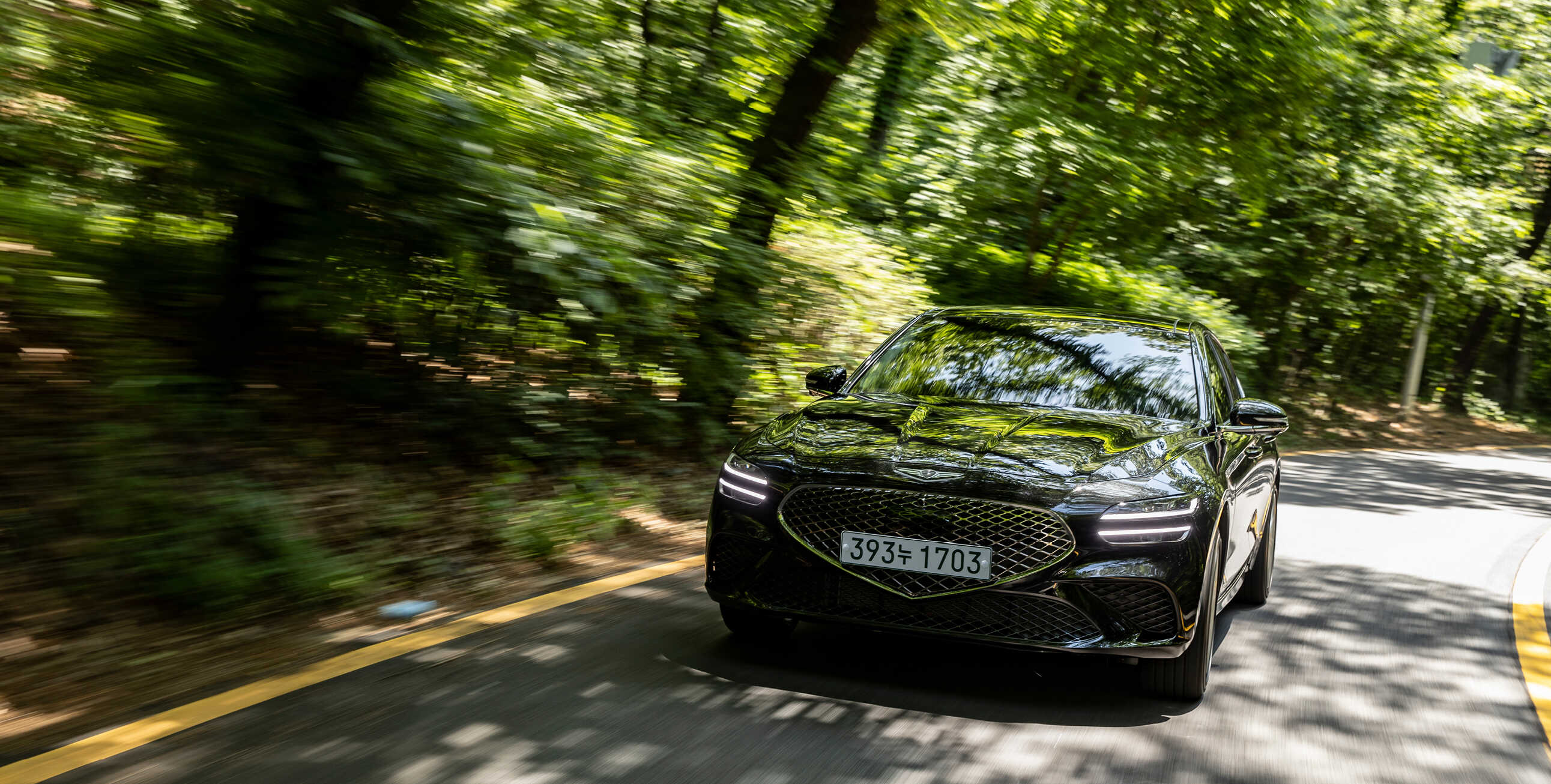 Front view of the G70 driving on a hill