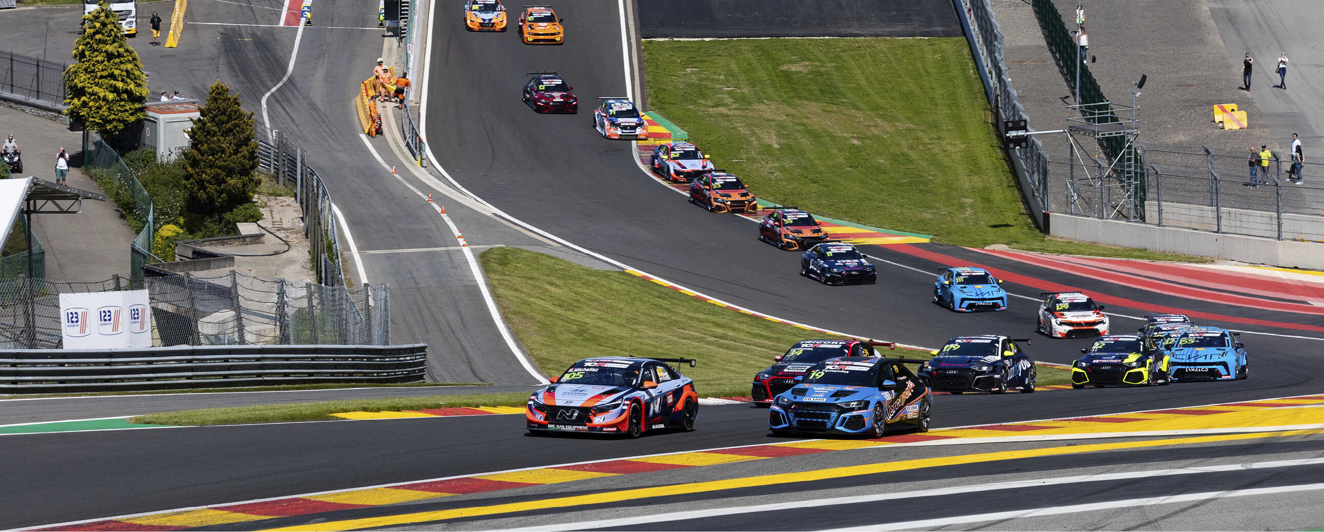 Race cars climb the Eau Rouge corner at Spa-Francorchamps