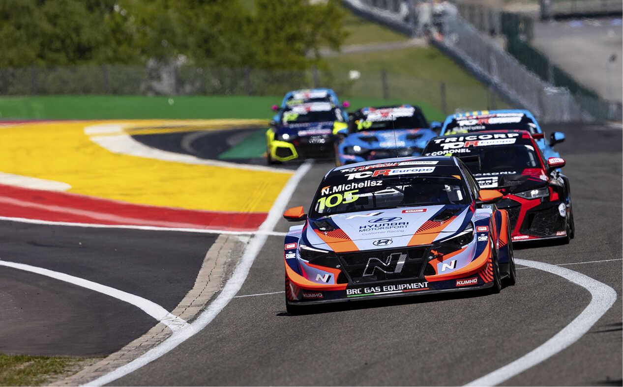 Race cars climb the Eau Rouge corner at Spa-Francorchamps
