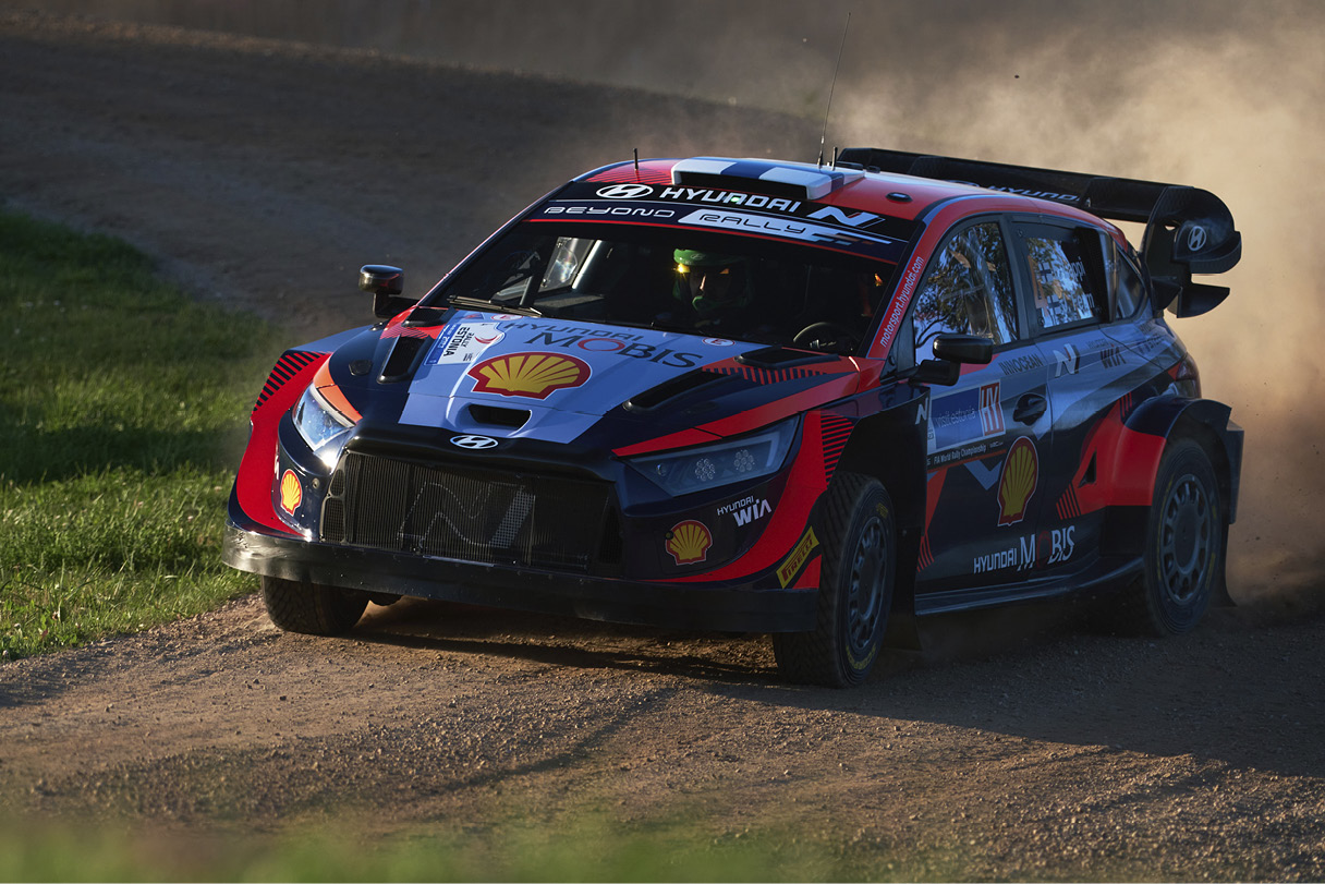 A rally car running through sand