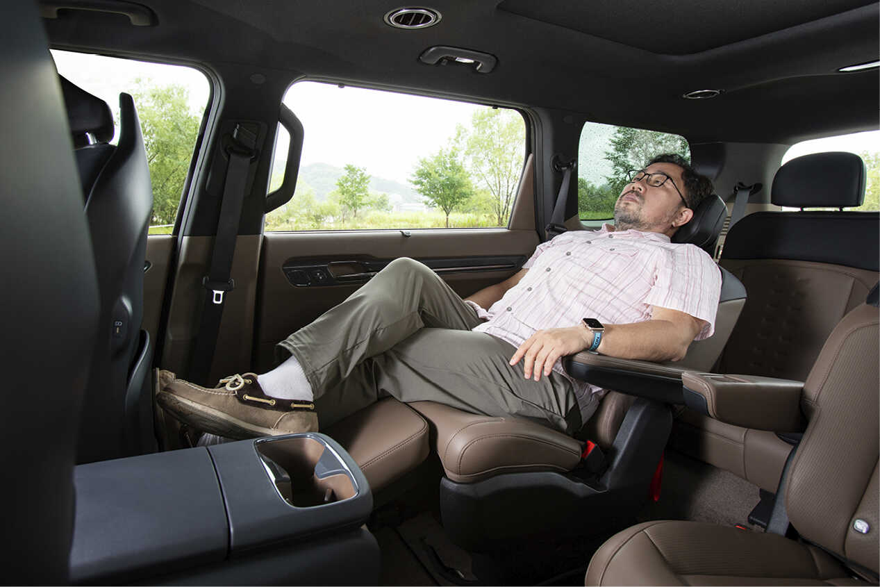 2열 독립 프리미엄 릴렉션 시트에 남성이 휴식을 취한 모습