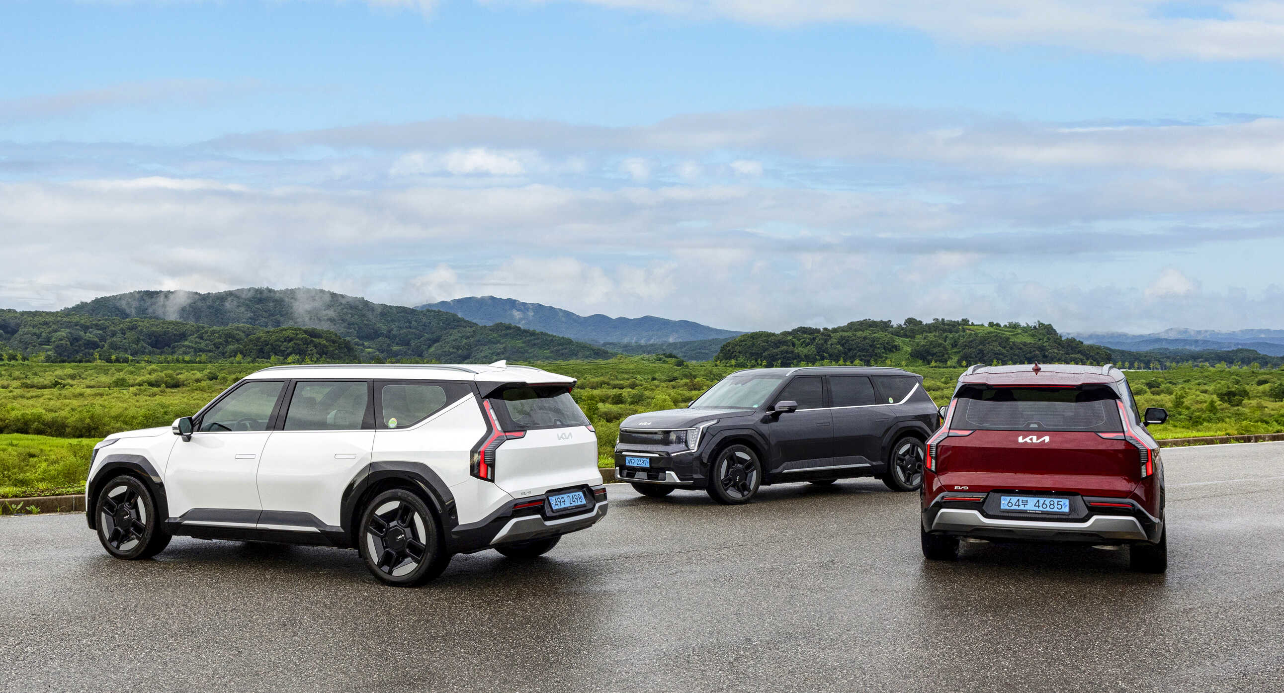 Three EV9s stopped on the road