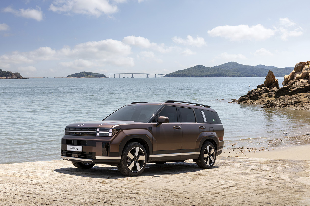 Hyundai the all new Santa Fe standing against the backdrop of the sea