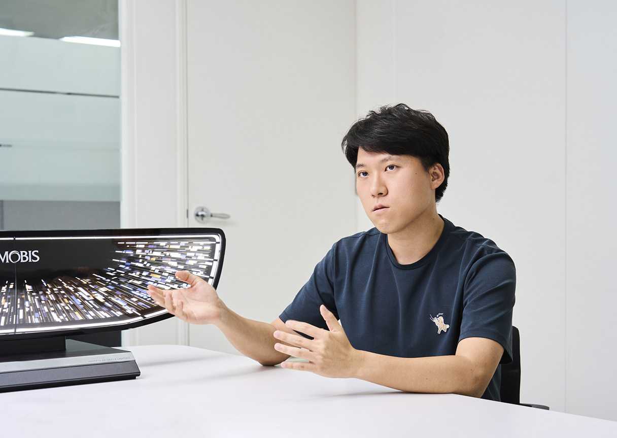 Researcher explaining the lenticular grille lighting system