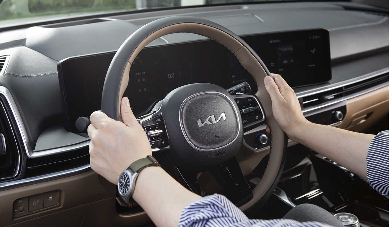 A man puts both hands on the steering wheel